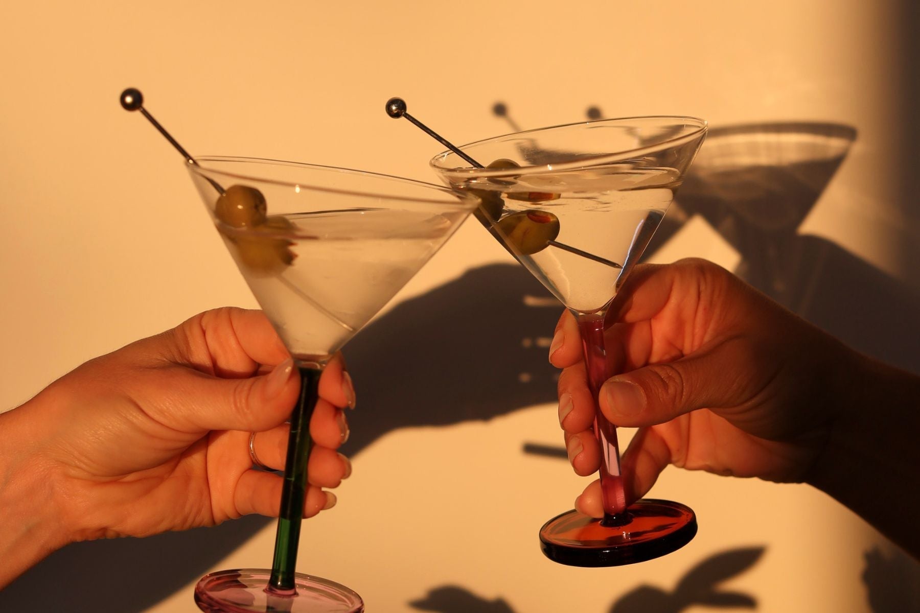 cocktail glasses clinking in sunlight