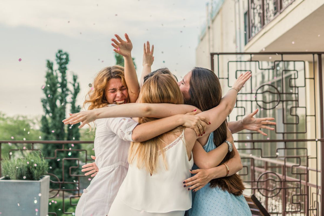 hugging bride and maids