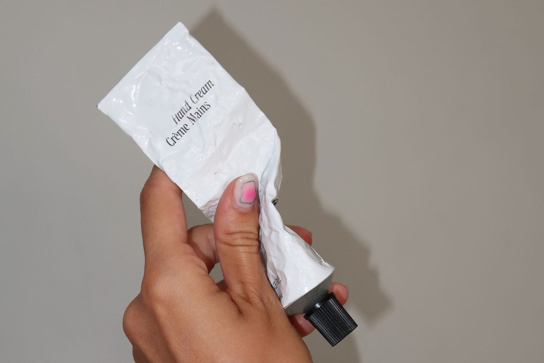 hand holding tube hand cream