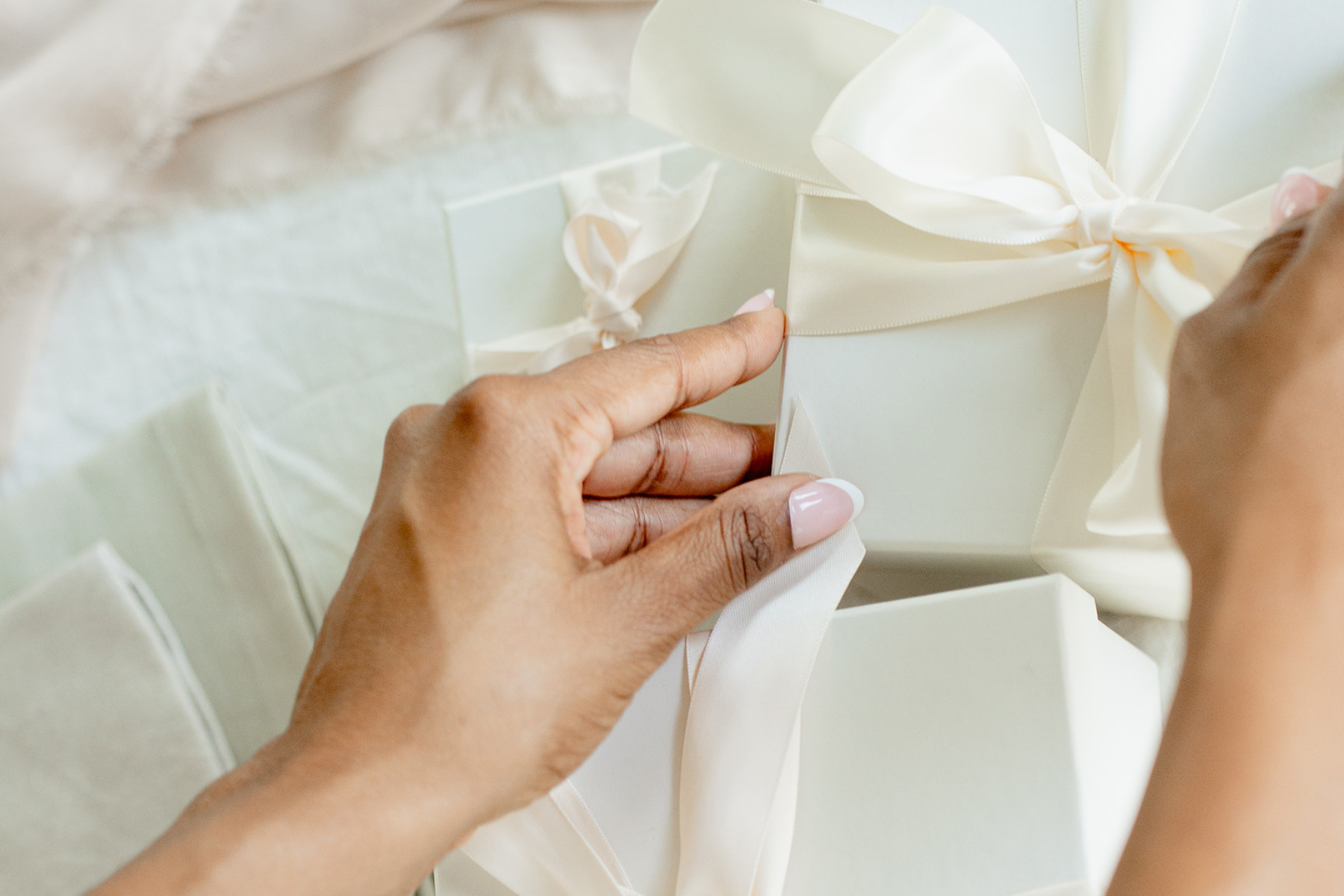 woman wrapping gifts with ribbon