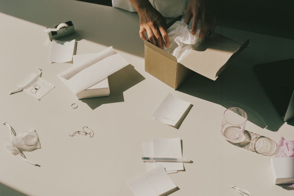 woman packaging a gift  on a table