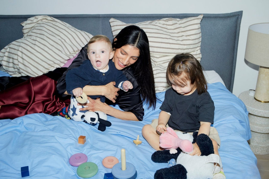 mom with 2 kids on the bed