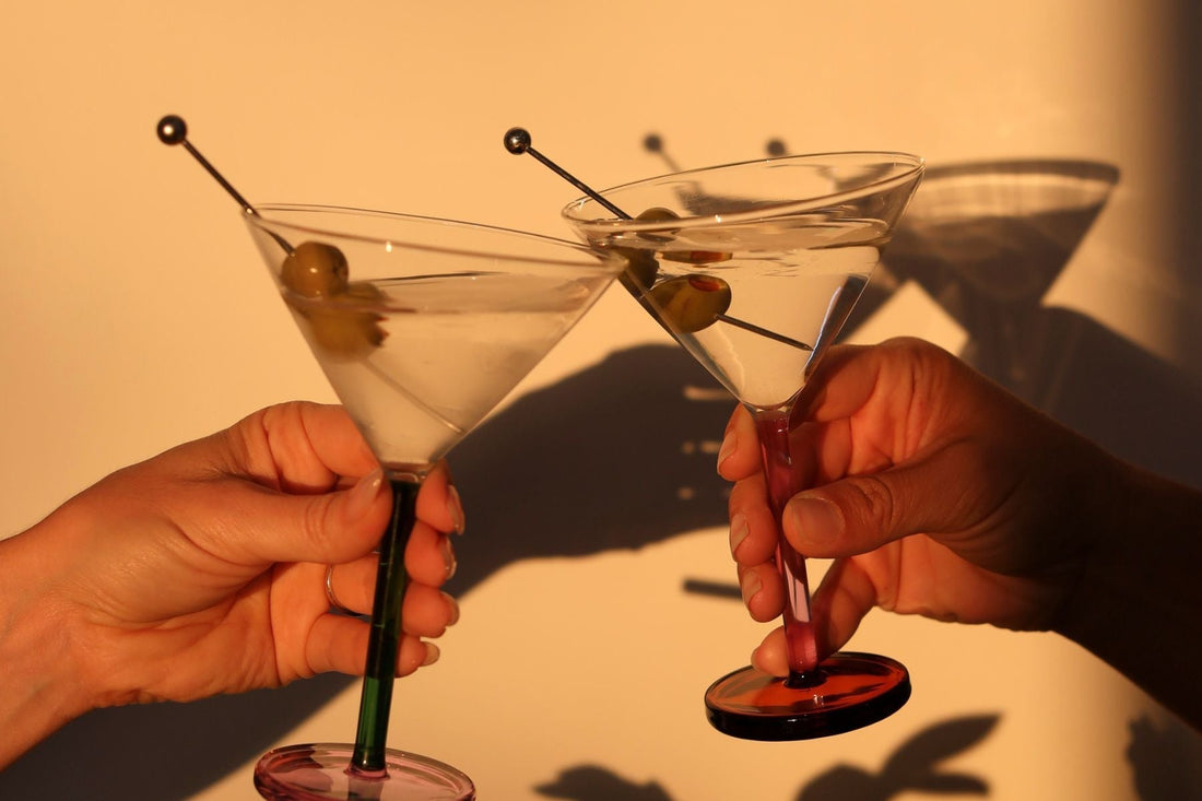 cocktail glasses clinking in sunlight