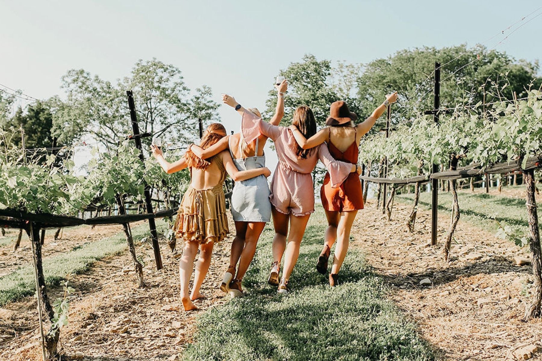 group of women hugging - photo taken from behind