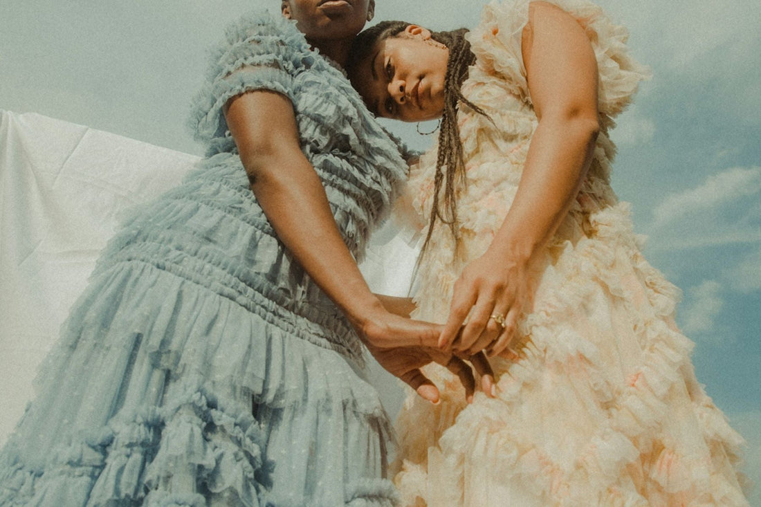 bride in cream dress with maid of honor in green dress