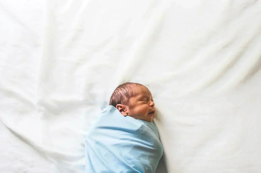 newborn on bed