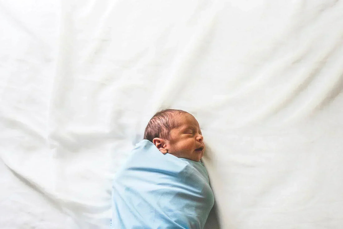 newborn on bed