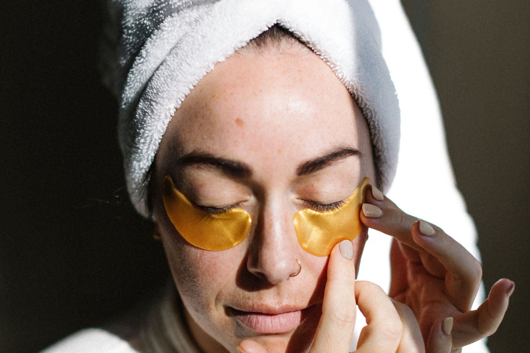 woman applying eye mask