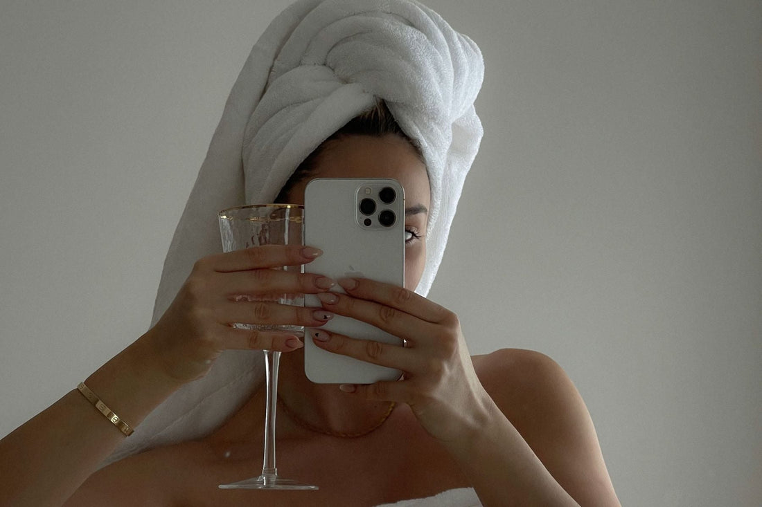 woman holding champagne and phone.jpg