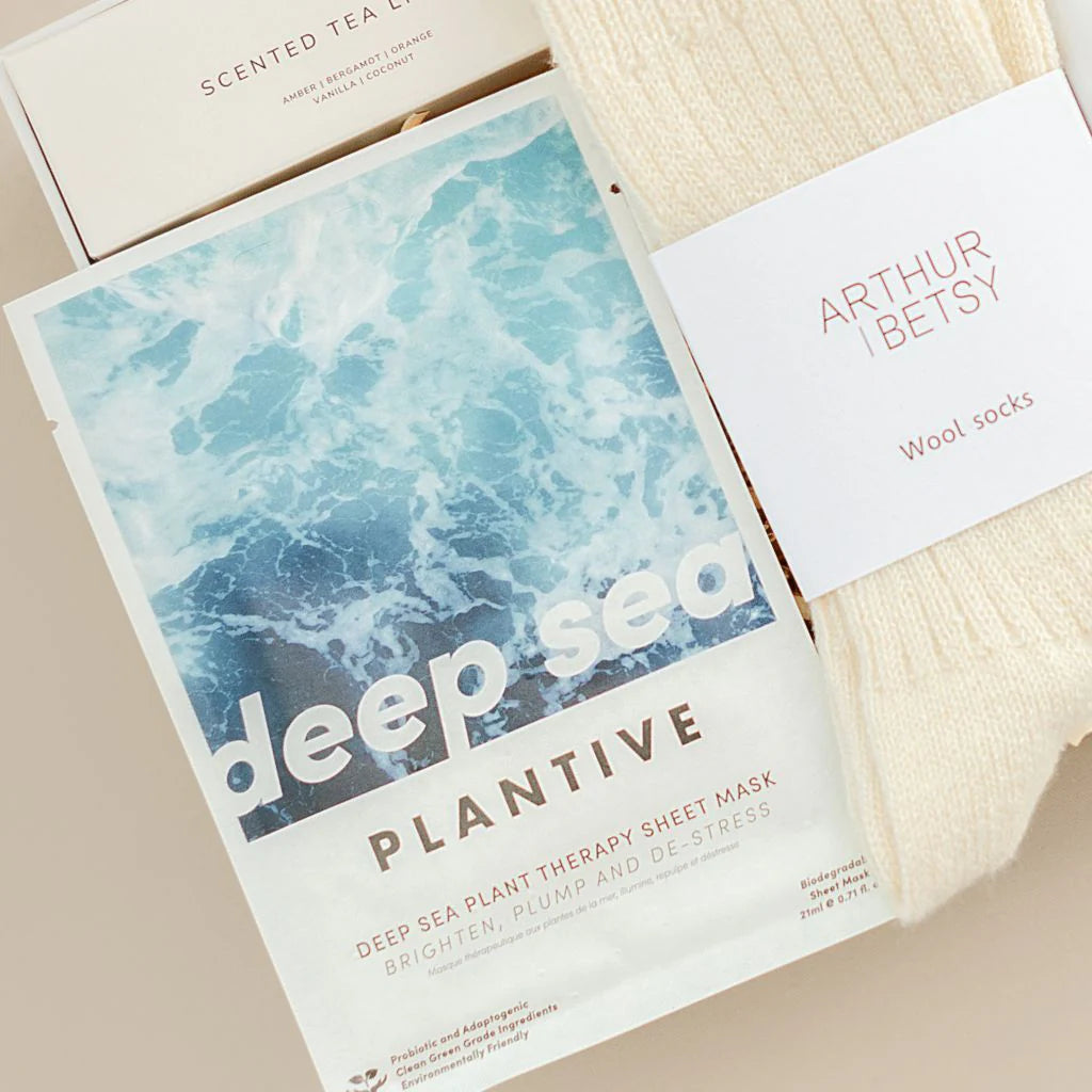 Plantive deep sea plant therapy sheet mask with a card and wool socks on a beige background